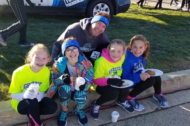 <p>Grizzly Running Club Coach/GMS Teacher Chad Clarey with some Grizzlies at the Marklund 5K. Photo courtesy of GMS Principal Jeff Modaff.</p>
