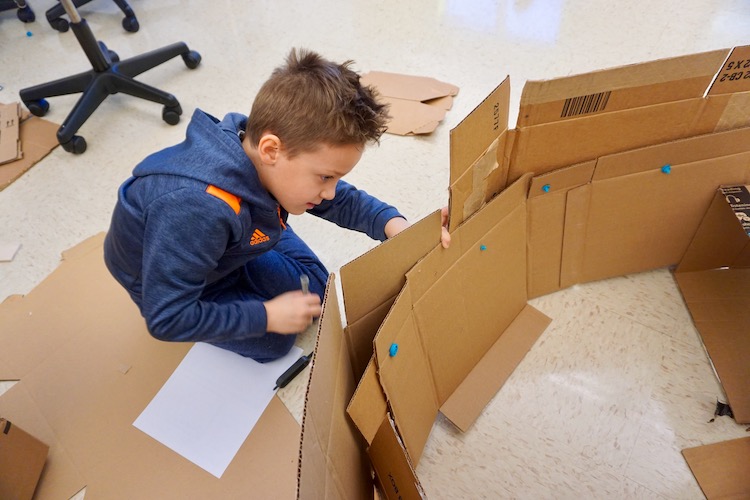 <p>A student using a “Makedo Scru” to build a house for Dog Man.</p>
